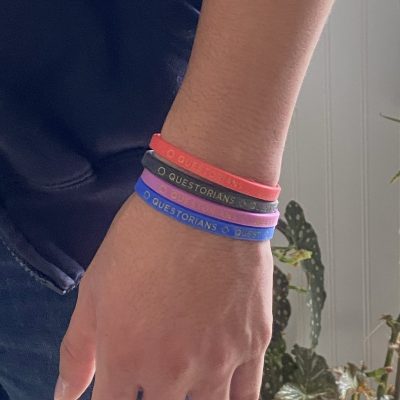 Four silicone wrist band on a wrist.